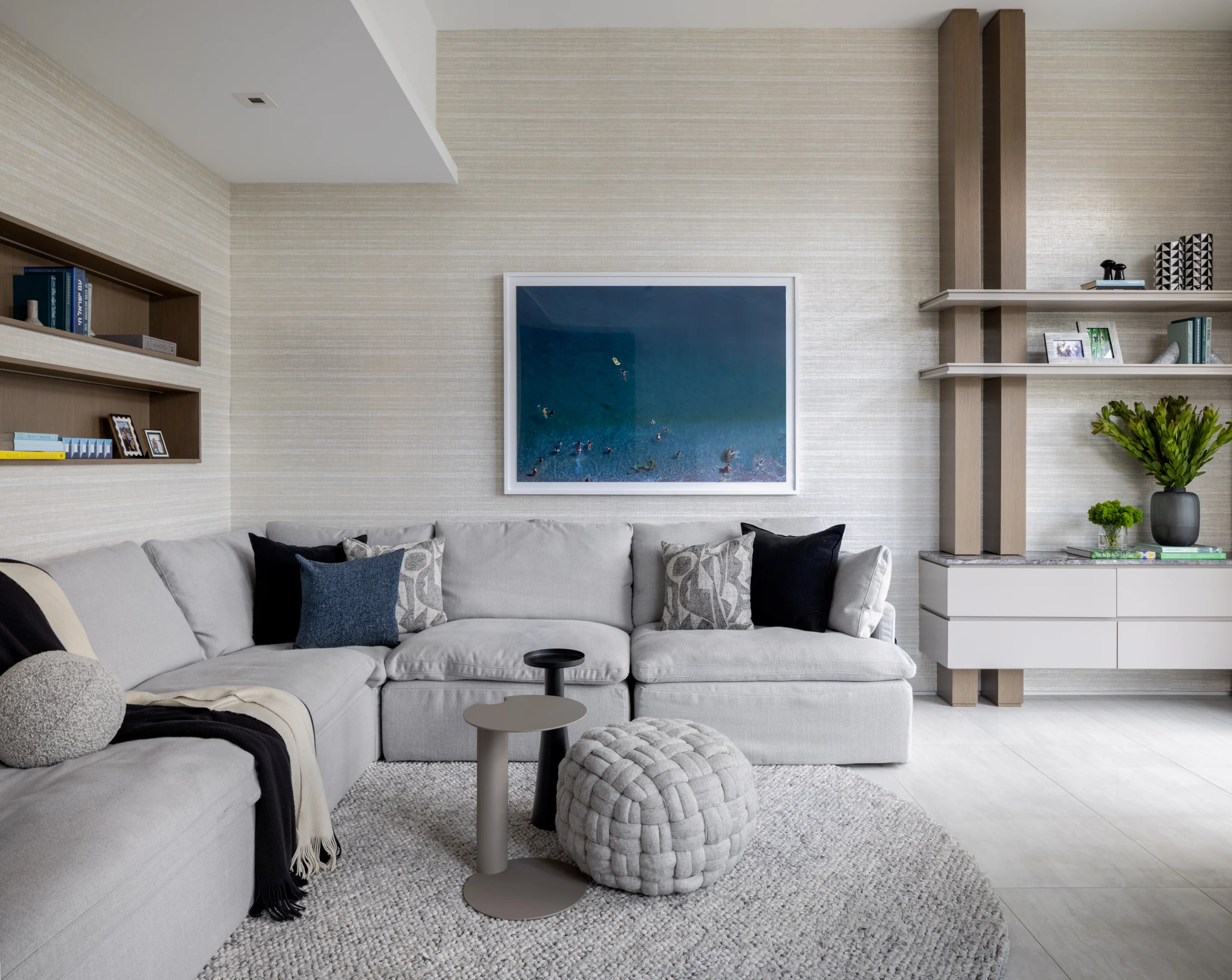 Cozy family room with sectional sofa, textured rug and custom wall shelving