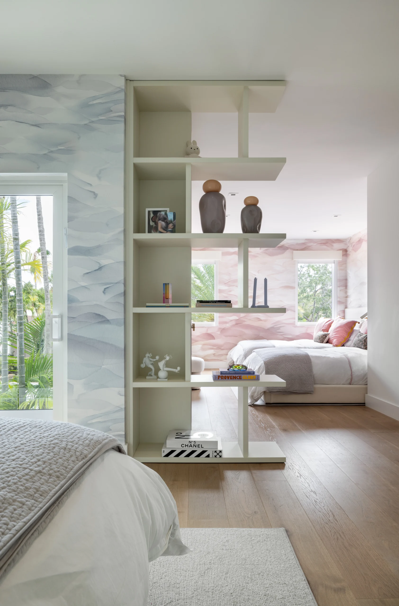 Open divider shelving connecting children's rooms with display decor and soft contemporary detailing