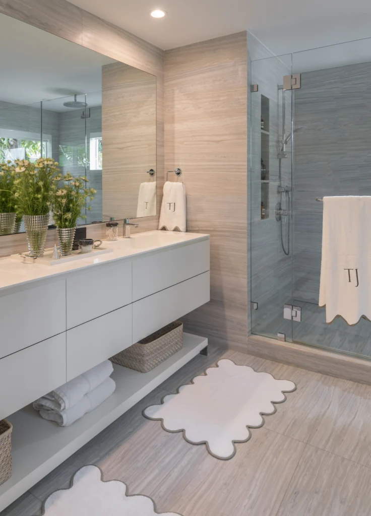 Contemporary bathroom with floating vanity, full-height mirror and glass-enclosed shower