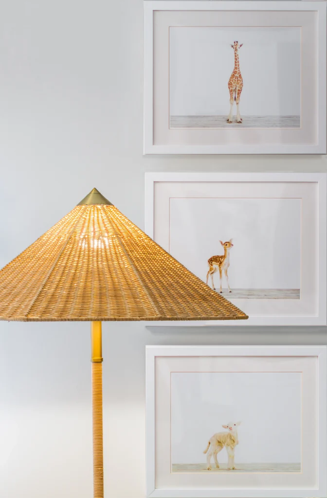 Warm children's room decor with woven table lamp and framed animal artwork